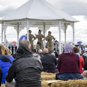 The RAF Cosford Air show, Sunday 8th June 2025 is the primary air show of the Royal Air Force attracting in excess of 55,000 visitors it is one of the biggest events in the West Midlands. This Years theme is ‘Commemorate, Celebrate, Innovate’. The air show will commemorate some of our history both in terms of assets and through displays in the Victory Village; Celebrate the work of the Royal Air Force, NATO Allies and Partner nations; And seek to inspire the next generation by showcasing how the armed forces innovate together and with our Defence sector partners in the STEM Hangar.
With displays, events and activities aiming to drive potential new recruits to kickstart their interest of a career in the RAF and develop an understanding of what the British Military, Allied Forces and Sister Services do for the defence of the United Kingdom. Visitors are able to get close to the cutting edge of technology with RAF Aircraft and unique attractions across the show ground and immerse themselves in a thrilling action-packed flying display programme.
The RAF Cosford Air show is an excellent way for the Ministry of Defence to engage with the public and showcase the Royal Air Force’s capabilities and to celebrate the service’s history while looking ahead to the next generation of people and technology.
RAF Cosford in Shropshire is a major part of the Defence College of Technical Training (DCTT). It is at the centre of the RAF’s mission to deliver flexible, affordable, modern and effective technical training that meets the needs of the UK’s Armed Forces now and into the future. RAF Apprenticeships delivered at RAF Cosford were recently recognised as ‘Outstanding’ by Ofsted. RAF Cosford is also home to the popular RAF Museum and the world-renowned Cosford Air show.
RAF Cosford opened in 1938 and is the home of RAF Engineering. The station currently trains all of the RAF’s Aircraft Technicians (Mechanical, Avionics, Weapons and Survival Equipment), Cyberspa