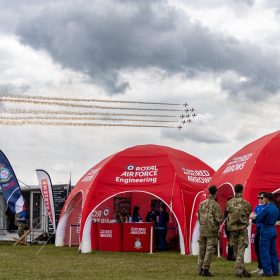The RAF Cosford Air show, Sunday 8th June 2025 is the primary air show of the Royal Air Force attracting in excess of 55,000 visitors it is one of the biggest events in the West Midlands. This Years theme is ‘Commemorate, Celebrate, Innovate’. The air show will commemorate some of our history both in terms of assets and through displays in the Victory Village; Celebrate the work of the Royal Air Force, NATO Allies and Partner nations; And seek to inspire the next generation by showcasing how the armed forces innovate together and with our Defence sector partners in the STEM Hangar.
With displays, events and activities aiming to drive potential new recruits to kickstart their interest of a career in the RAF and develop an understanding of what the British Military, Allied Forces and Sister Services do for the defence of the United Kingdom. Visitors are able to get close to the cutting edge of technology with RAF Aircraft and unique attractions across the show ground and immerse themselves in a thrilling action-packed flying display programme.
The RAF Cosford Air show is an excellent way for the Ministry of Defence to engage with the public and showcase the Royal Air Force’s capabilities and to celebrate the service’s history while looking ahead to the next generation of people and technology.
RAF Cosford in Shropshire is a major part of the Defence College of Technical Training (DCTT). It is at the centre of the RAF’s mission to deliver flexible, affordable, modern and effective technical training that meets the needs of the UK’s Armed Forces now and into the future. RAF Apprenticeships delivered at RAF Cosford were recently recognised as ‘Outstanding’ by Ofsted. RAF Cosford is also home to the popular RAF Museum and the world-renowned Cosford Air show.
RAF Cosford opened in 1938 and is the home of RAF Engineering. The station currently trains all of the RAF’s Aircraft Technicians (Mechanical, Avionics, Weapons and Survival Equipment), Cyberspa